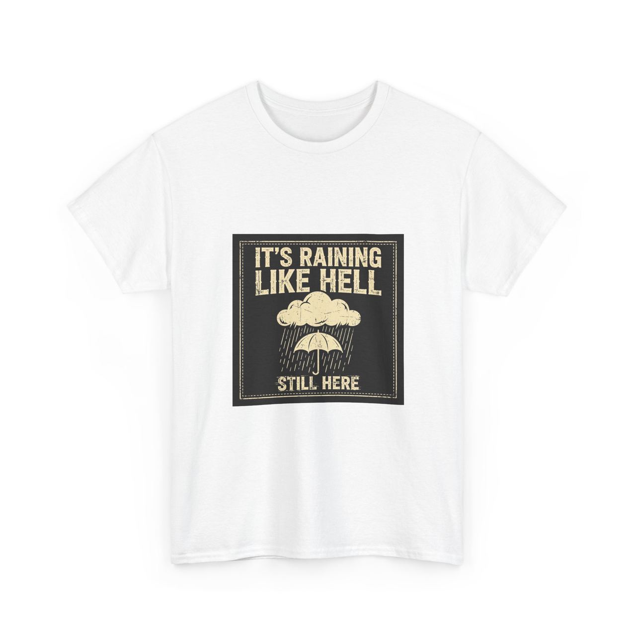 White t-shirt with a black stitched-look patch: a rain cloud over an umbrella reading ‘It’s Raining Like Hell’ and ‘Still Here’