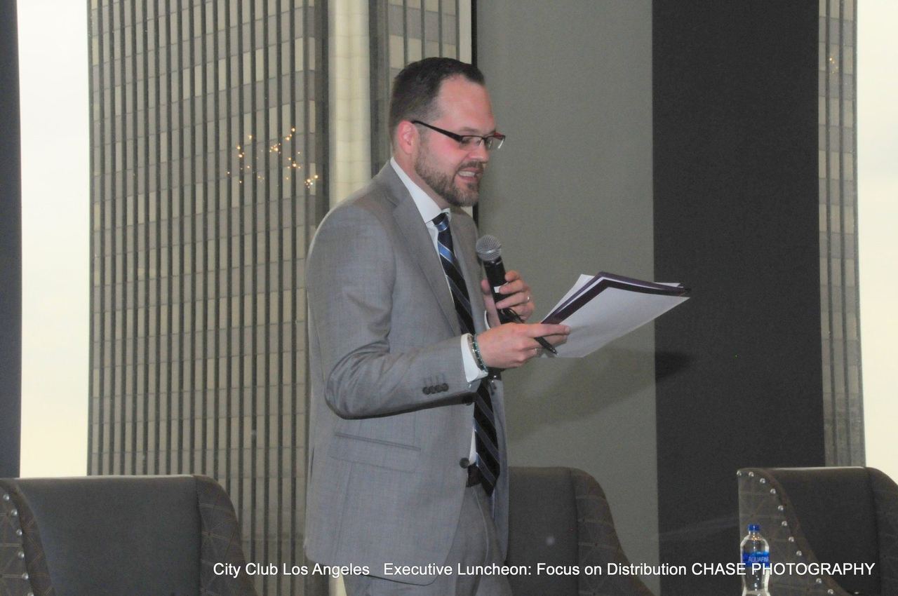David Strausser speaking on stage at City Club Los Angeles